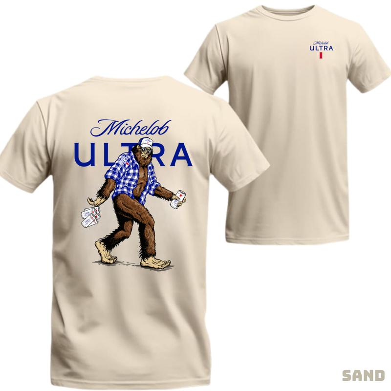 Michelob ULTRA – Funny Bigfoot in flannel holding beers graphic, bold and playful design, unisex cotton T-shirt for men and women, great for parties or outings Menswear Top Streetwear Casual Tropical