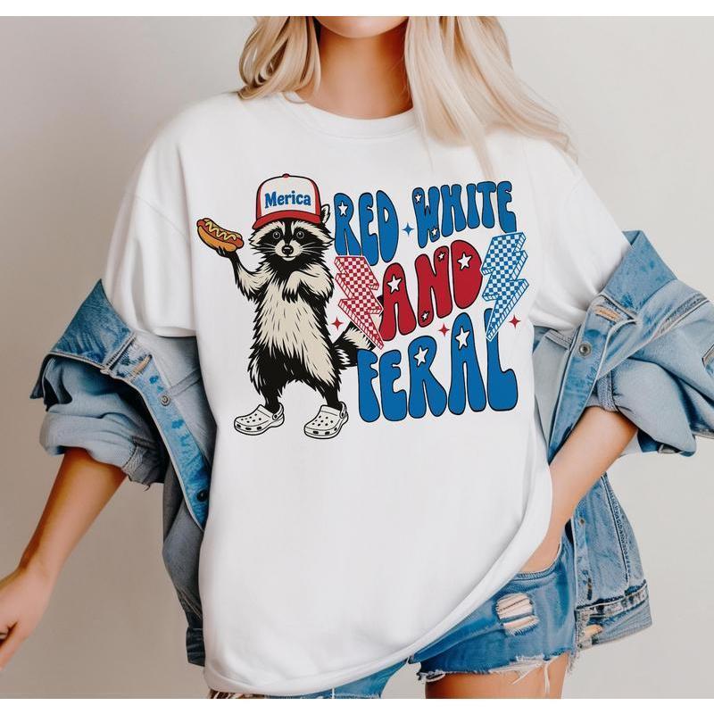 Trendy T – Shirt Featuring a Cool Raccoon: Stylish ‘Merica’ Look with Catchy ‘Red White and Feral’ Typography